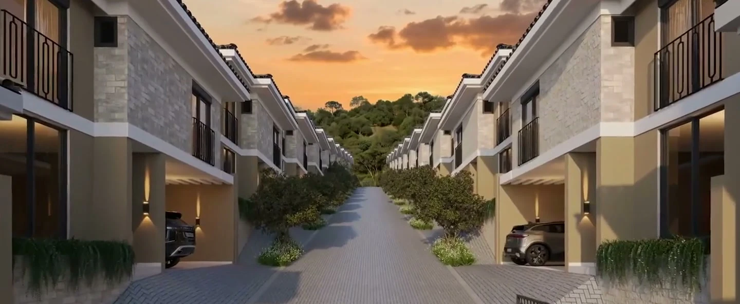 Perspectiva das casas do Le Champ Village ao pôr do sol